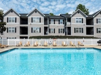 An apartment building with a large swimming pool